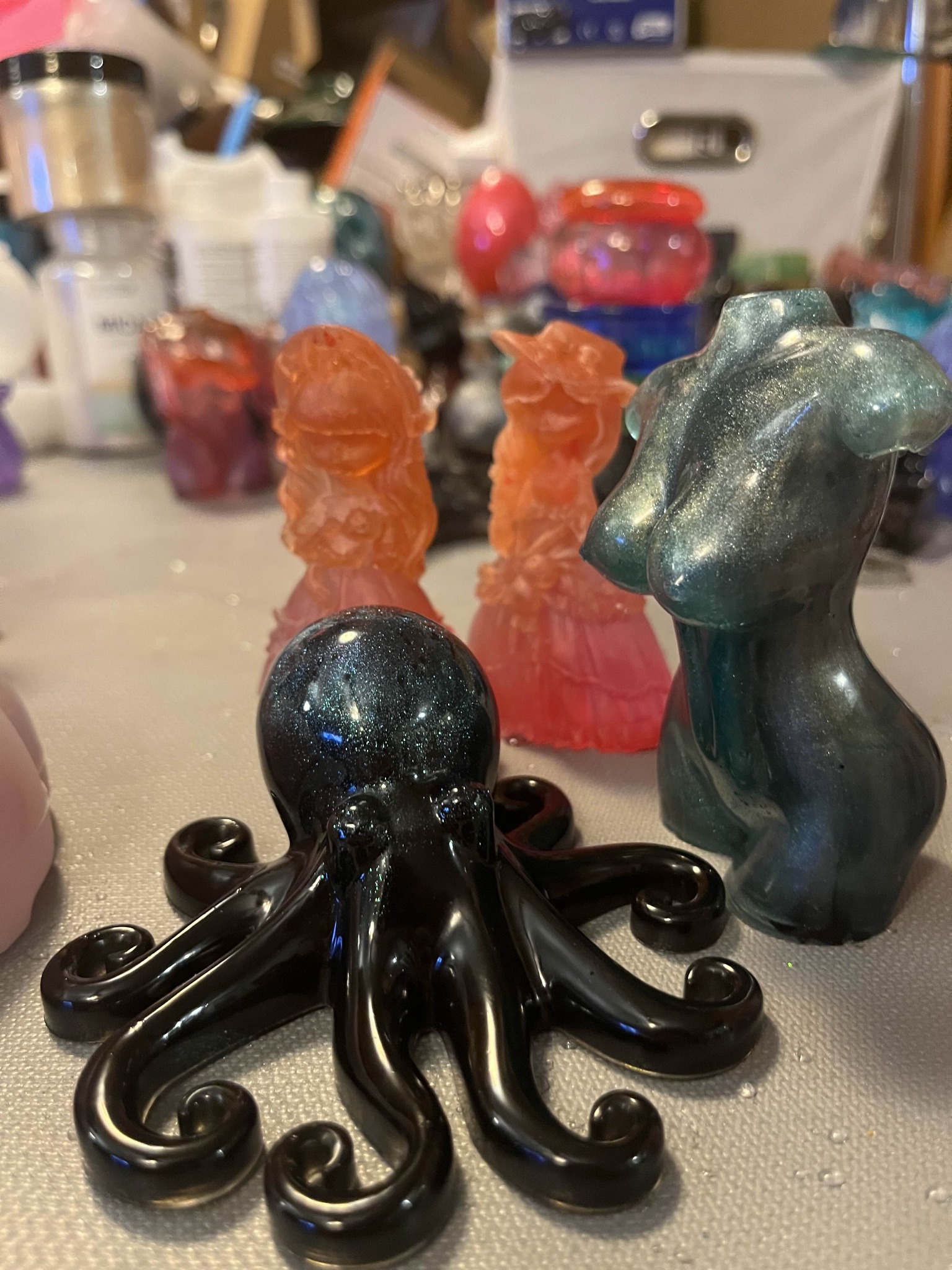Galaxy-black resin octopus with goddess torsos