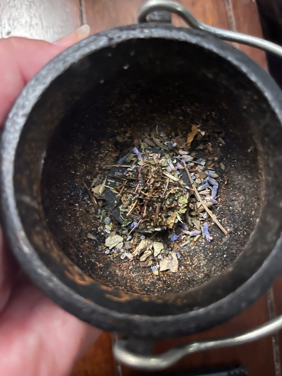 Cast iron cauldron holding ritual herbs