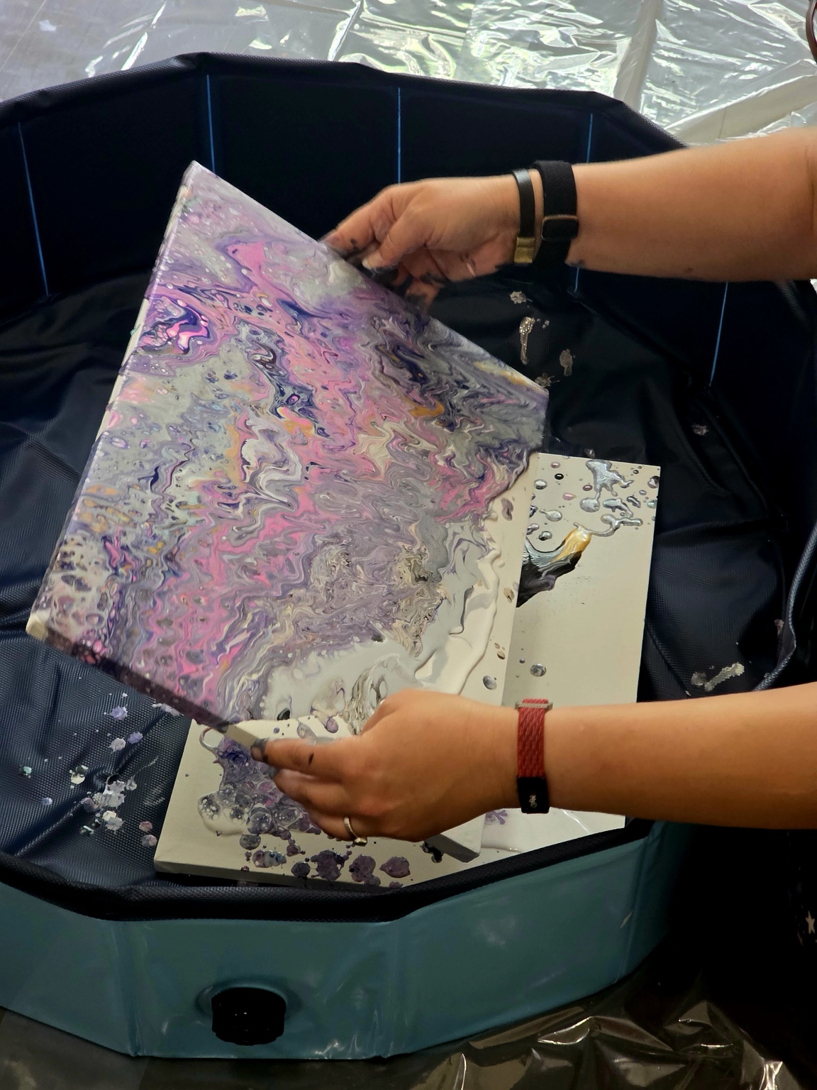 Inferna working on a fluid art pour