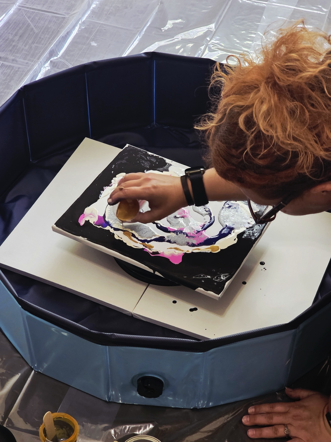 Inferna preparing a fluid art canvas